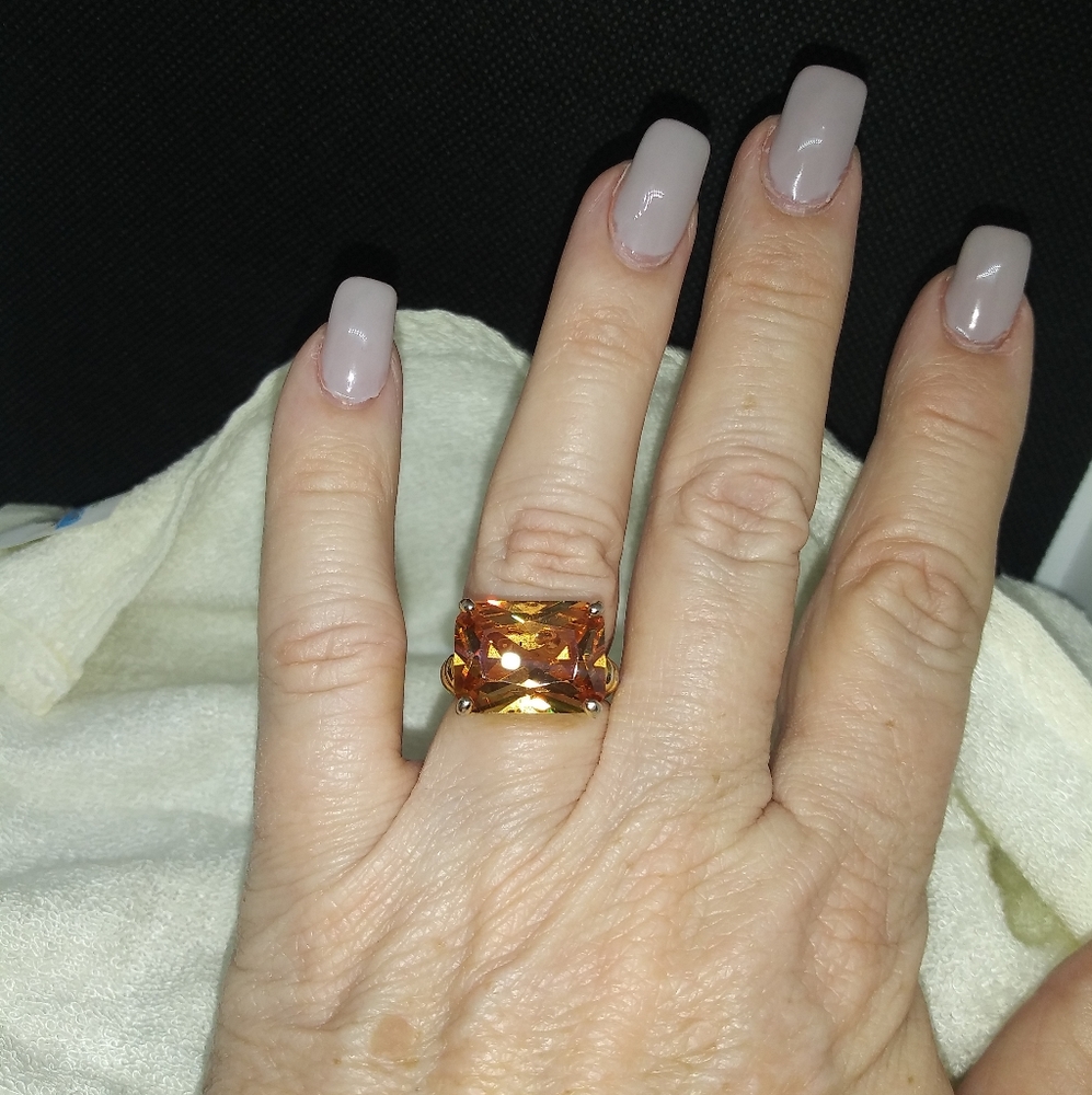 Amber crystal in goldtone setting.   Size 7